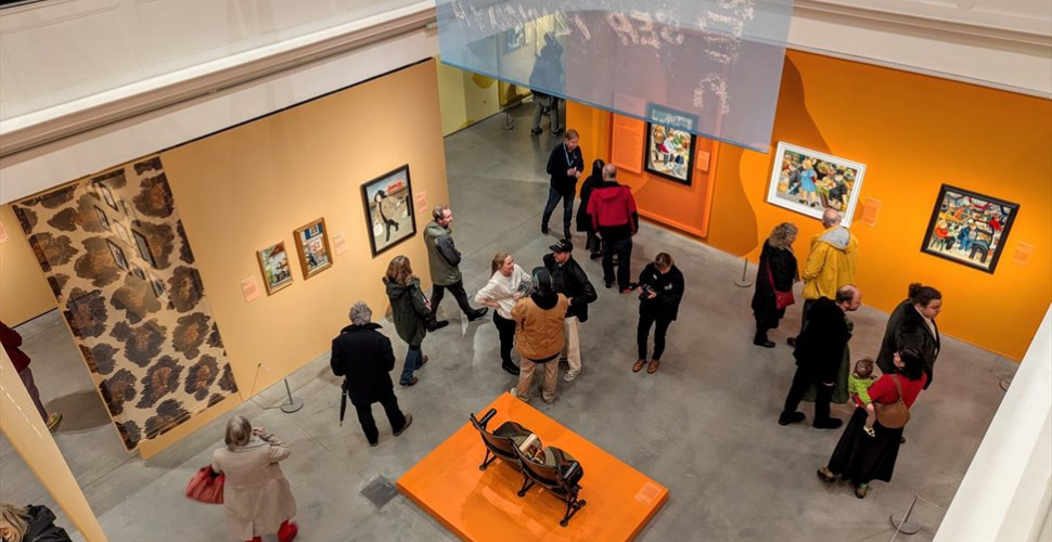 Visitors looking at Beryl cook Exhibition at The Box Plymouth